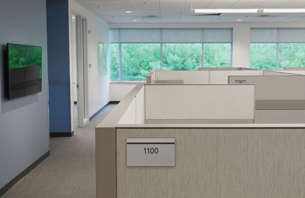 Office cubicles marked by signs