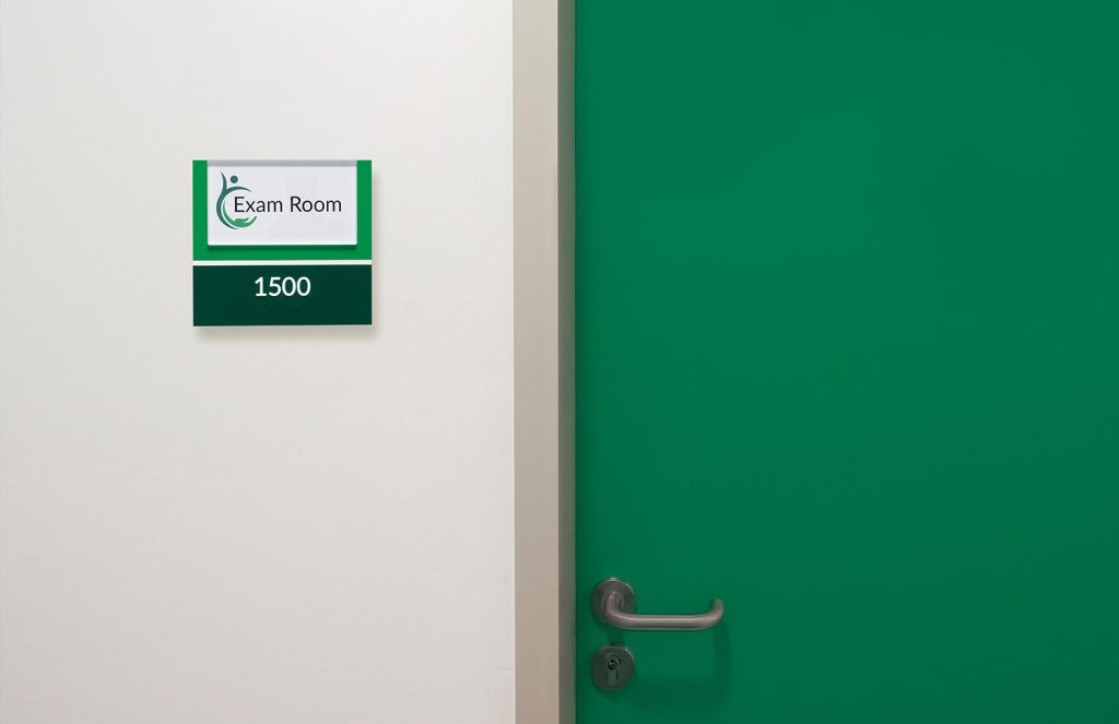 Exam room signage door