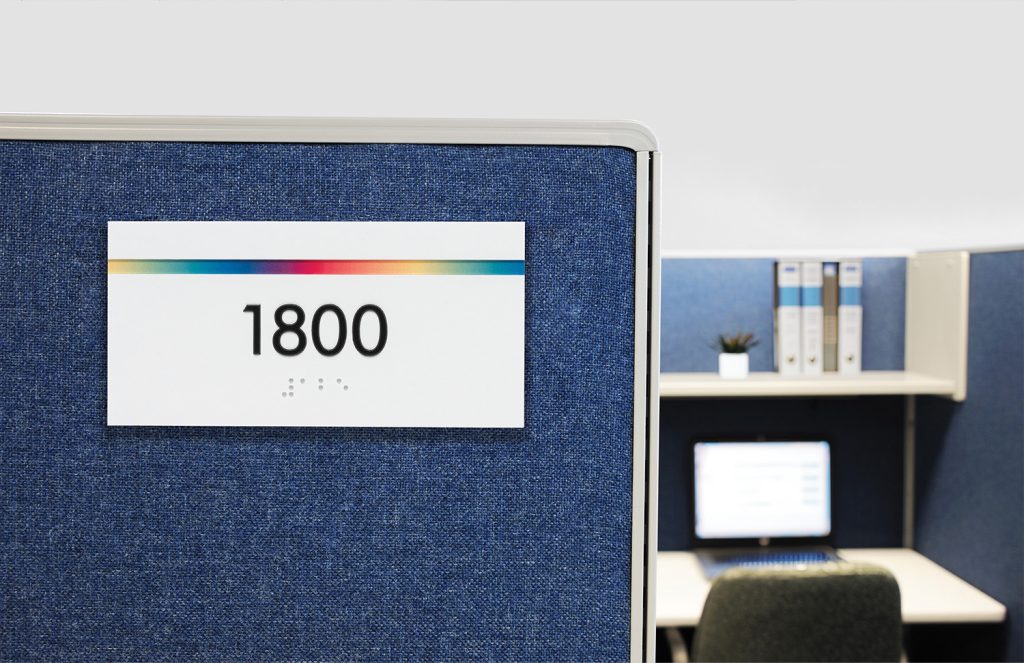 office cubicle marked by rainbow interior signage