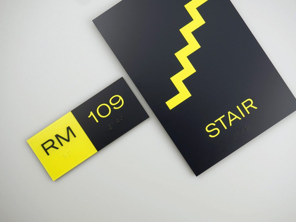 matching custom interior signage for the stairwell and room number