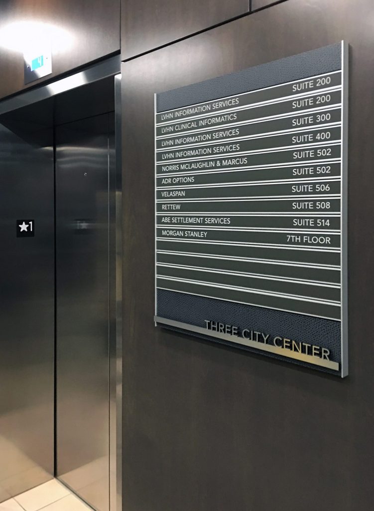 interior wayfinding slatz paper signage by elevator